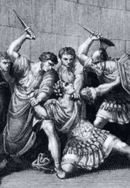 Gravura em preto e branco retratando o assassinato do imperador romano Calígula. Ele está ajoelhado ou caído no chão, vestindo trajes imperiais ornamentados, enquanto vários homens o cercam com adagas erguidas. Um dos agressores segura seu braço; outro, à direita, usa armadura militar. A cena é tensa e dramática, com expressões faciais intensas e movimento sugerido pelas roupas e posturas.